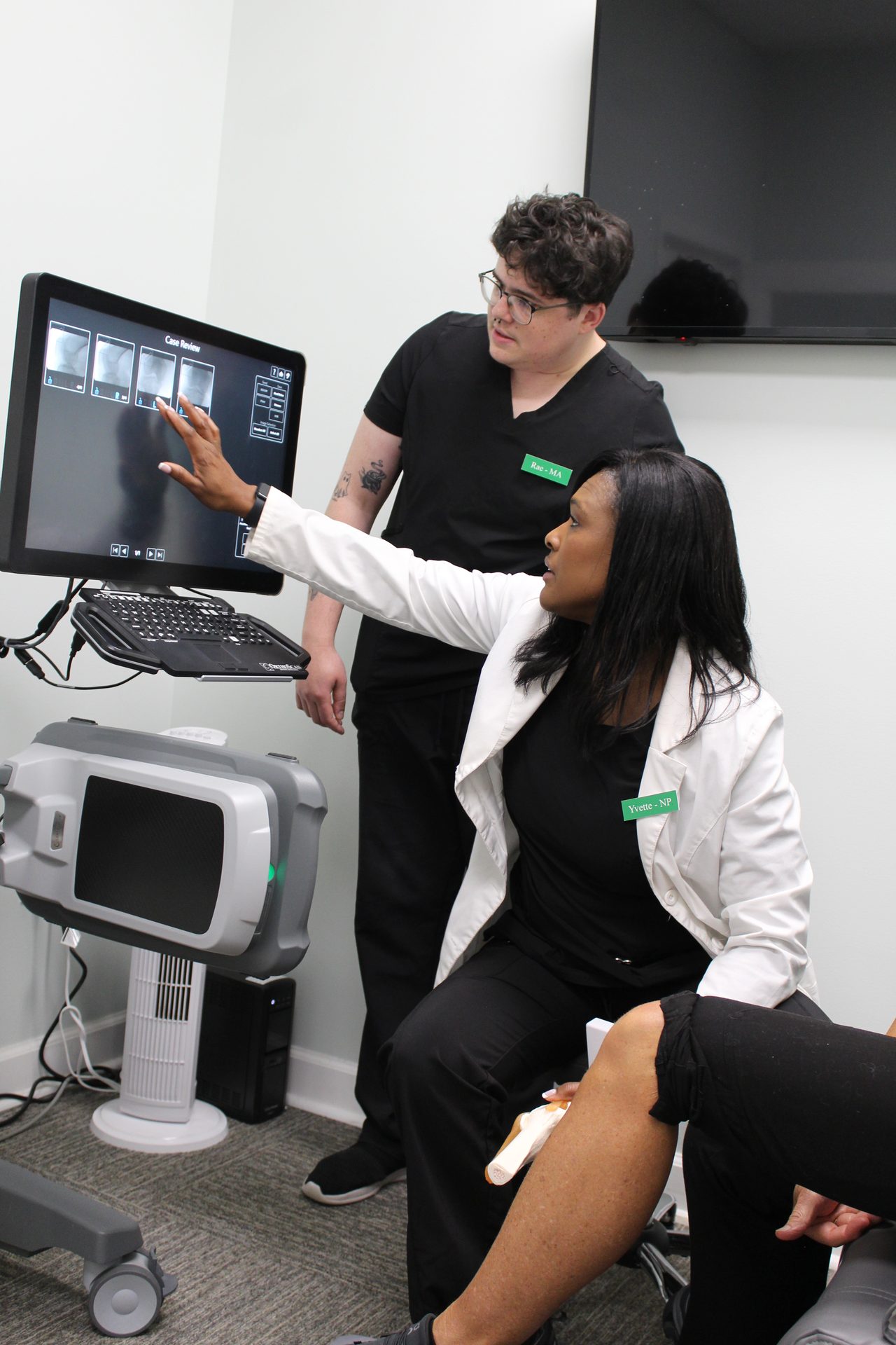 Vitality care team discussing a knee evaluation with a patient in the Overland Park office.