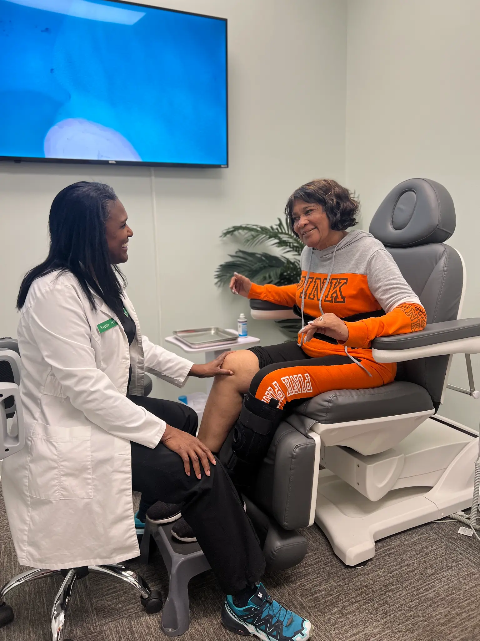 A Vitality provider with a patient during a knee assessment in the clinic.
